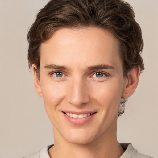 Joyful white young-adult female with short  brown hair and grey eyes