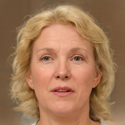 Joyful white middle-aged female with medium  blond hair and brown eyes