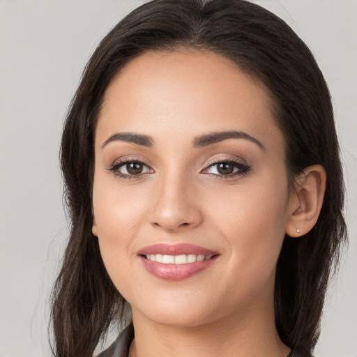 Joyful white young-adult female with long  brown hair and brown eyes