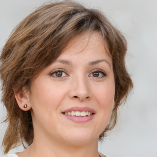 Joyful white young-adult female with medium  brown hair and blue eyes