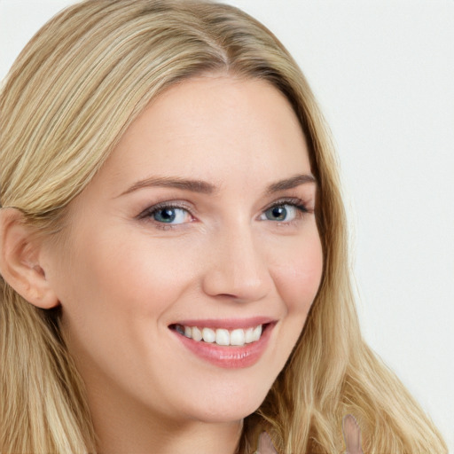 Joyful white young-adult female with long  brown hair and blue eyes