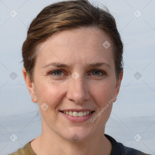 Joyful white adult female with short  brown hair and grey eyes