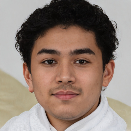 Joyful latino young-adult male with short  brown hair and brown eyes