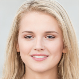 Joyful white young-adult female with long  brown hair and blue eyes