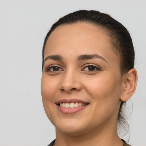 Joyful white young-adult female with short  black hair and brown eyes