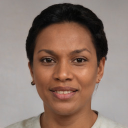Joyful latino young-adult female with short  black hair and brown eyes