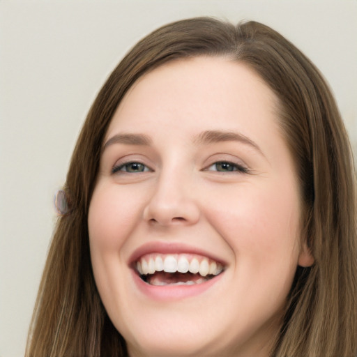 Joyful white young-adult female with long  brown hair and green eyes