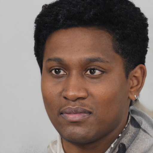 Neutral black young-adult male with short  black hair and brown eyes