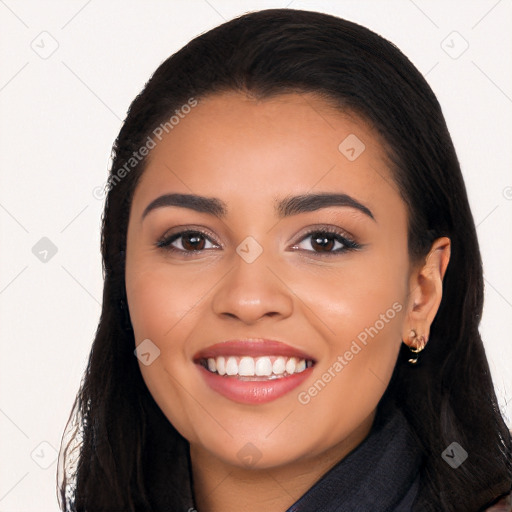 Joyful latino young-adult female with long  black hair and brown eyes