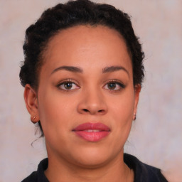 Joyful black young-adult female with long  brown hair and brown eyes