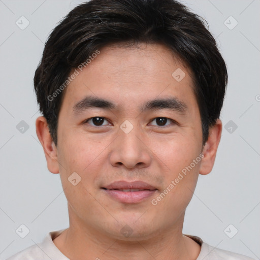 Joyful asian young-adult male with short  brown hair and brown eyes