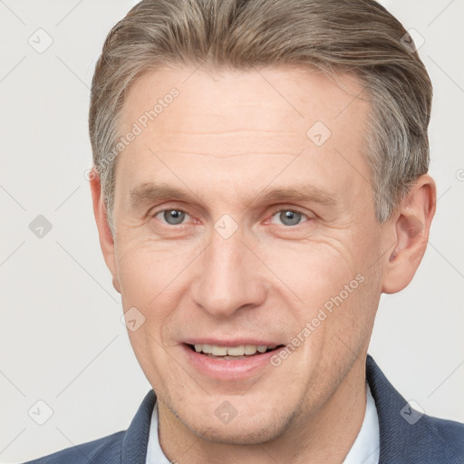 Joyful white adult male with short  brown hair and grey eyes