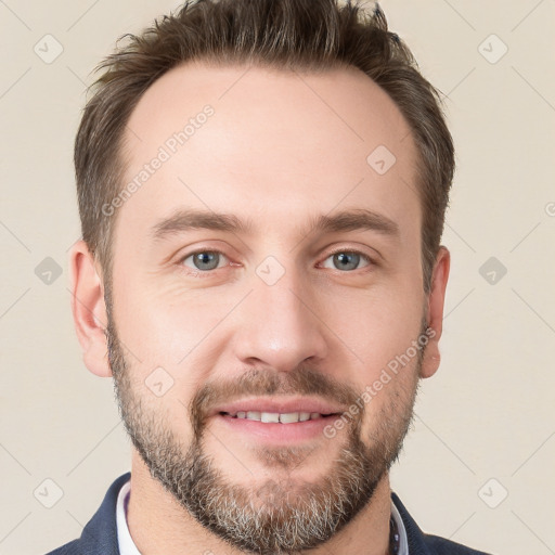 Joyful white young-adult male with short  brown hair and grey eyes