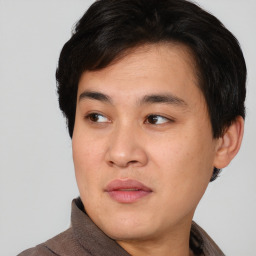 Joyful asian young-adult male with short  black hair and brown eyes