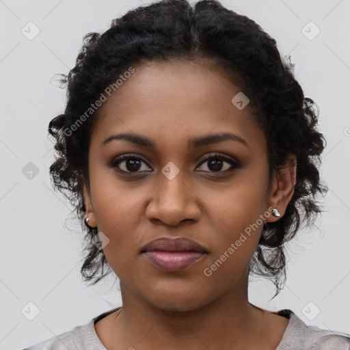 Joyful black young-adult female with medium  black hair and brown eyes