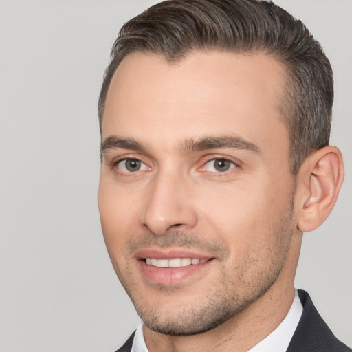 Joyful white young-adult male with short  brown hair and brown eyes