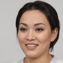 Joyful asian young-adult female with medium  brown hair and brown eyes