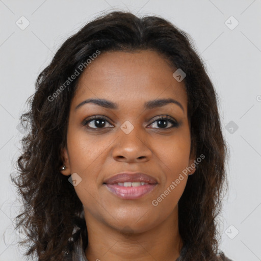 Joyful black young-adult female with long  brown hair and brown eyes