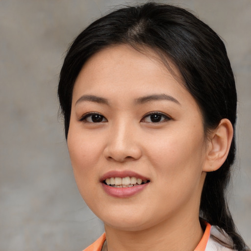 Joyful asian young-adult female with medium  black hair and brown eyes