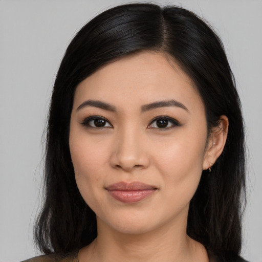 Joyful latino young-adult female with long  black hair and brown eyes