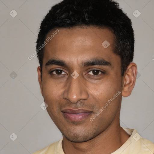 Joyful black young-adult male with short  black hair and brown eyes