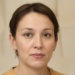 Joyful white adult female with short  brown hair and brown eyes