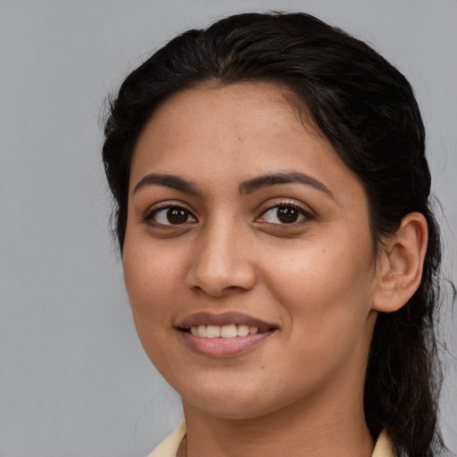 Joyful latino young-adult female with medium  black hair and brown eyes
