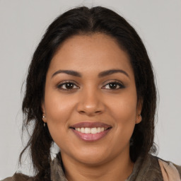 Joyful latino young-adult female with long  brown hair and brown eyes