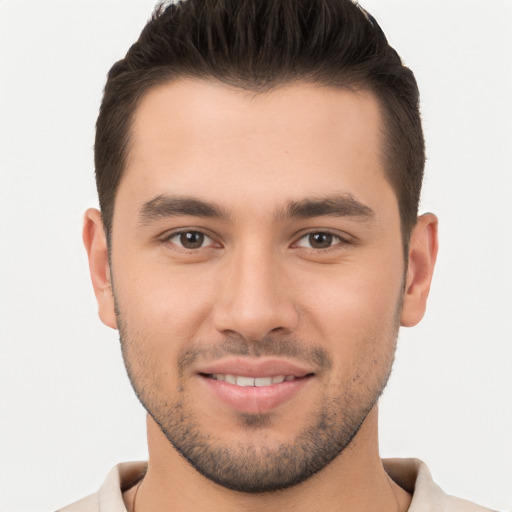 Joyful white young-adult male with short  brown hair and brown eyes