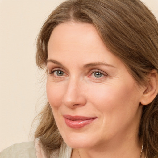 Joyful white adult female with long  brown hair and brown eyes