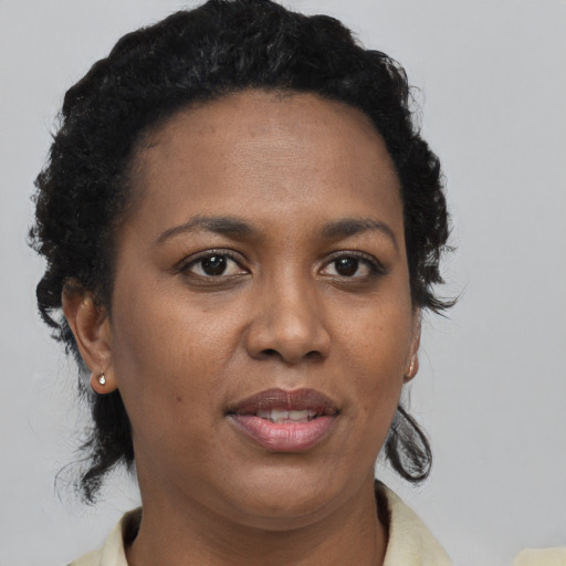 Joyful black adult female with short  brown hair and brown eyes