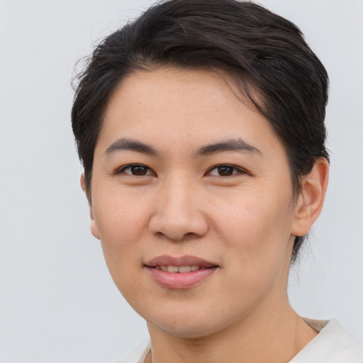 Joyful asian young-adult female with short  brown hair and brown eyes