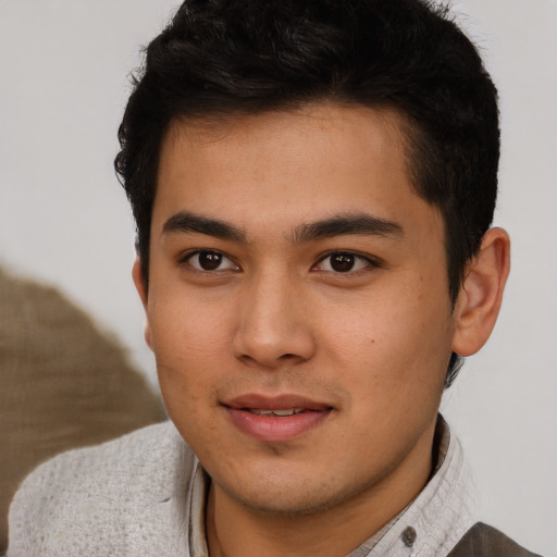 Joyful latino young-adult male with short  brown hair and brown eyes