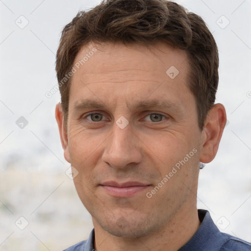 Joyful white adult male with short  brown hair and grey eyes