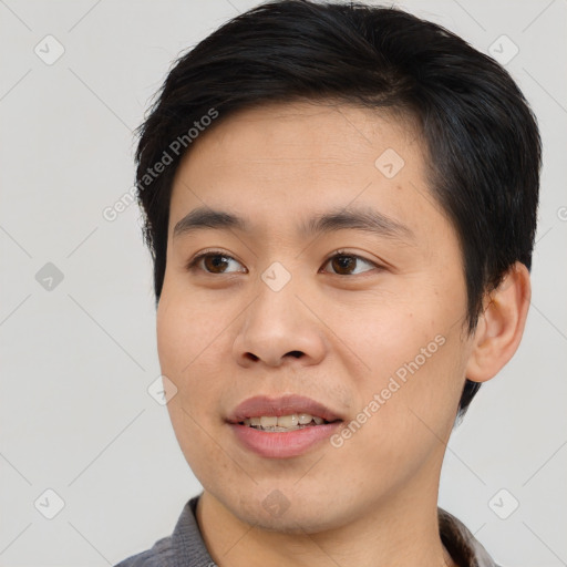 Joyful asian young-adult male with short  brown hair and brown eyes