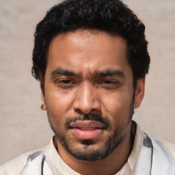 Joyful white young-adult male with short  black hair and brown eyes