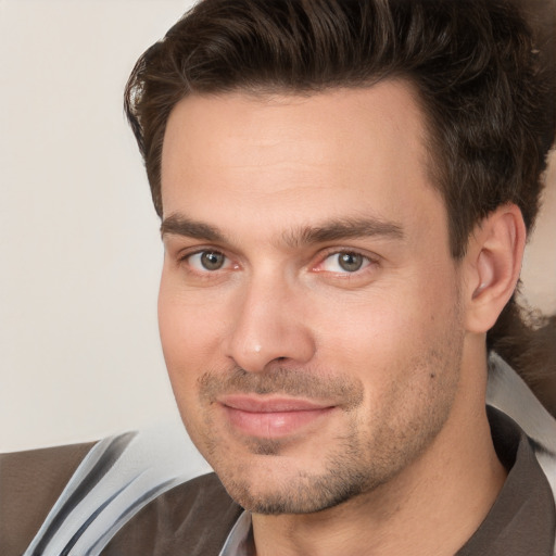 Joyful white adult male with short  brown hair and brown eyes