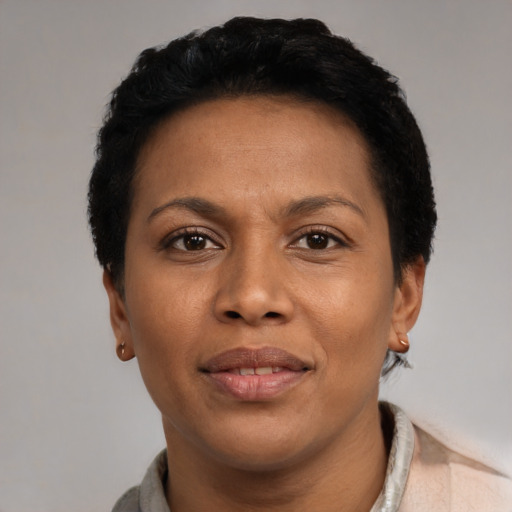 Joyful black adult female with short  black hair and brown eyes