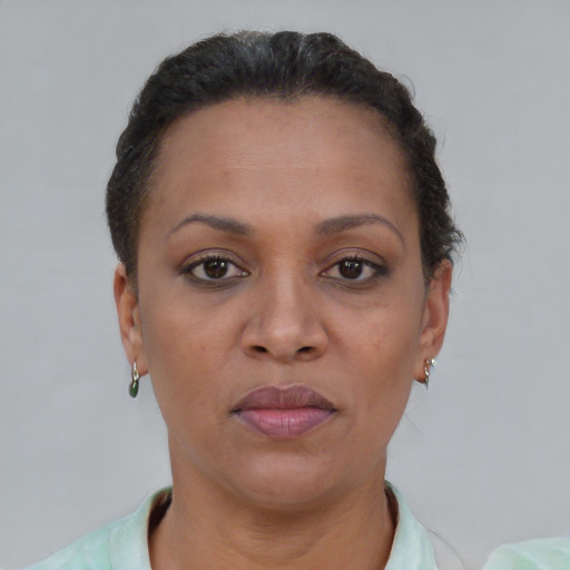 Joyful black adult female with short  brown hair and brown eyes