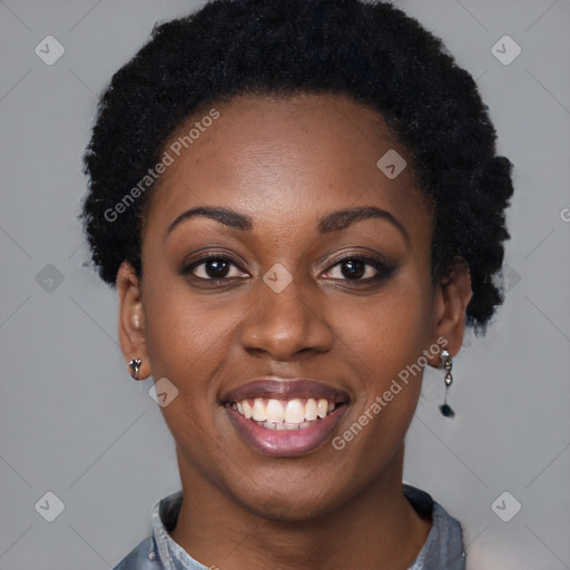 Joyful black young-adult female with short  black hair and brown eyes