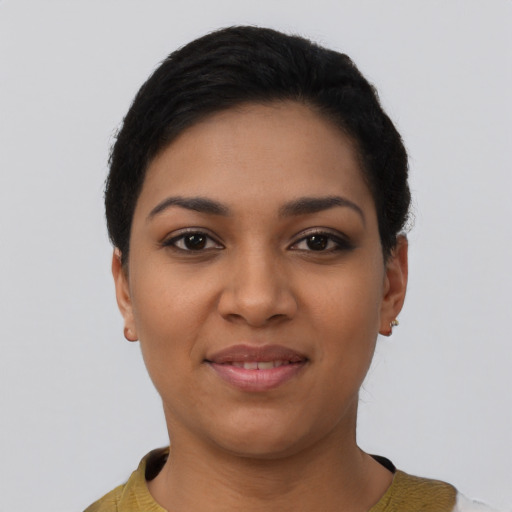 Joyful latino young-adult female with short  black hair and brown eyes