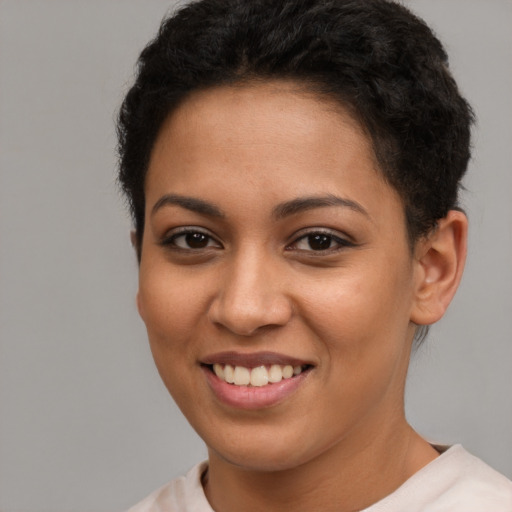 Joyful latino young-adult female with short  brown hair and brown eyes