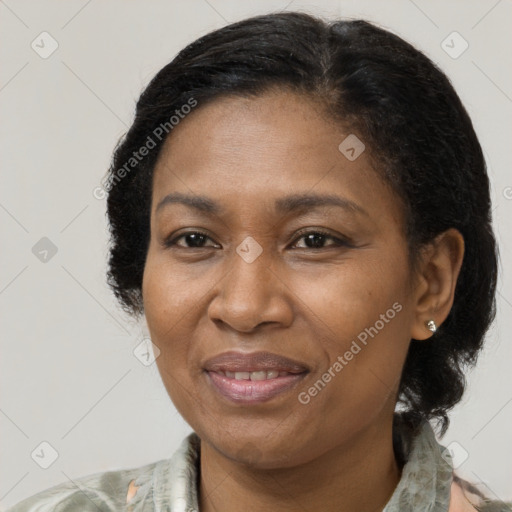 Joyful black adult female with medium  brown hair and brown eyes