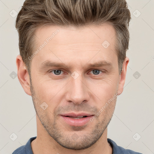 Joyful white adult male with short  brown hair and grey eyes