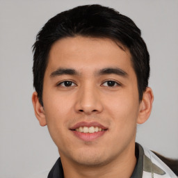 Joyful asian young-adult male with short  black hair and brown eyes