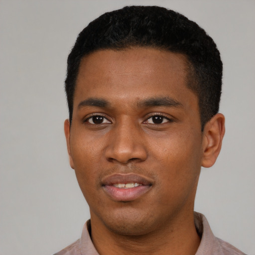 Joyful black young-adult male with short  black hair and brown eyes