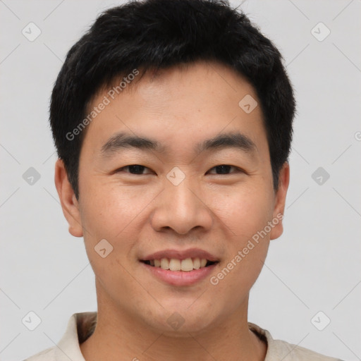 Joyful asian young-adult male with short  brown hair and brown eyes