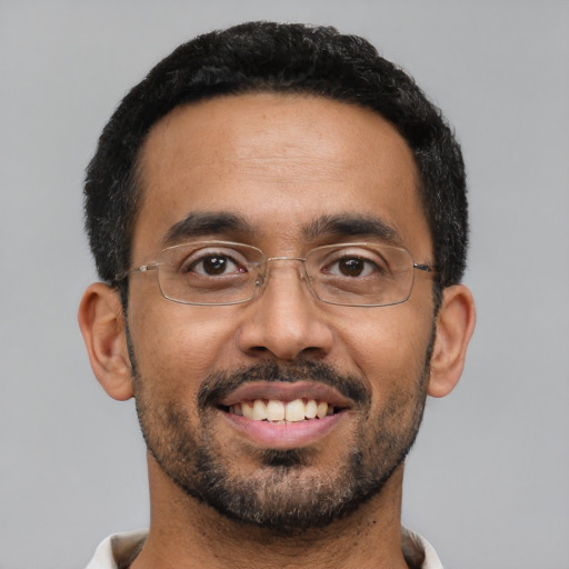 Joyful latino young-adult male with short  black hair and brown eyes