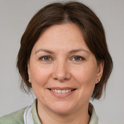 Joyful white adult female with medium  brown hair and brown eyes