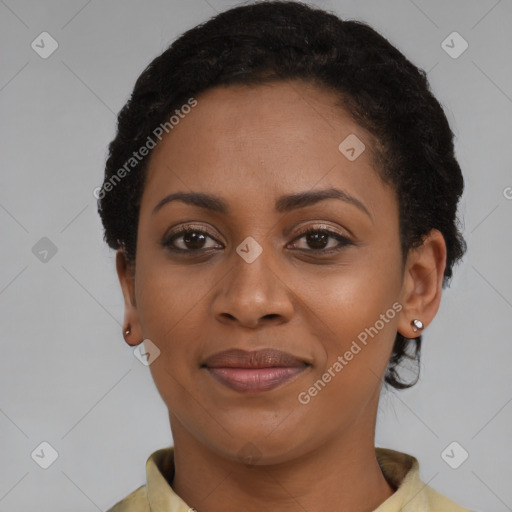 Joyful black young-adult female with short  black hair and brown eyes